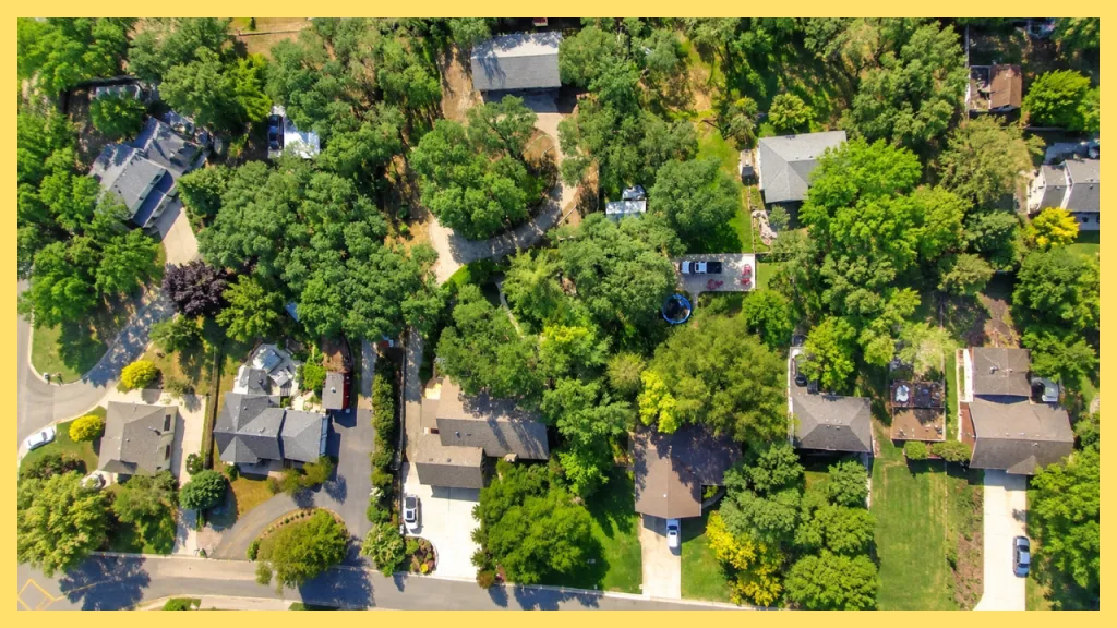 An aerial view of a tree lined residential neighborhood in Granite Bay, California, featuring spacious homes on large lots surrounded by mature oak trees and landscaped streets. The image highlights the area's established neighborhoods, generous property sizes, and peaceful suburban setting that make Granite Bay a popular choice for homebuyers seeking privacy and natural beauty.