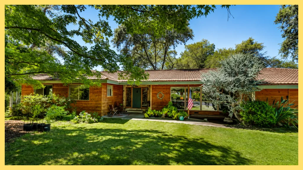 A charming single story home in Shelborne Estates, Granite Bay, California, featuring warm cedar siding, a tile roof, expansive front lawn, mature shade trees, and beautifully landscaped gardens. Nestled on a spacious lot with established greenery, the property reflects the quiet, park like setting of Shelborne Estates, a sought after neighborhood known for custom homes, large lots, and peaceful suburban living.