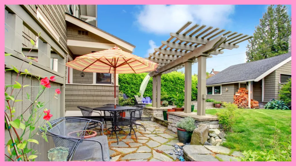 Outdoor patio and backyard of a single family home featuring a pergola, stone patio, outdoor seating, and detached structure, representing the benefits of FHA manual underwriting for homebuyers.