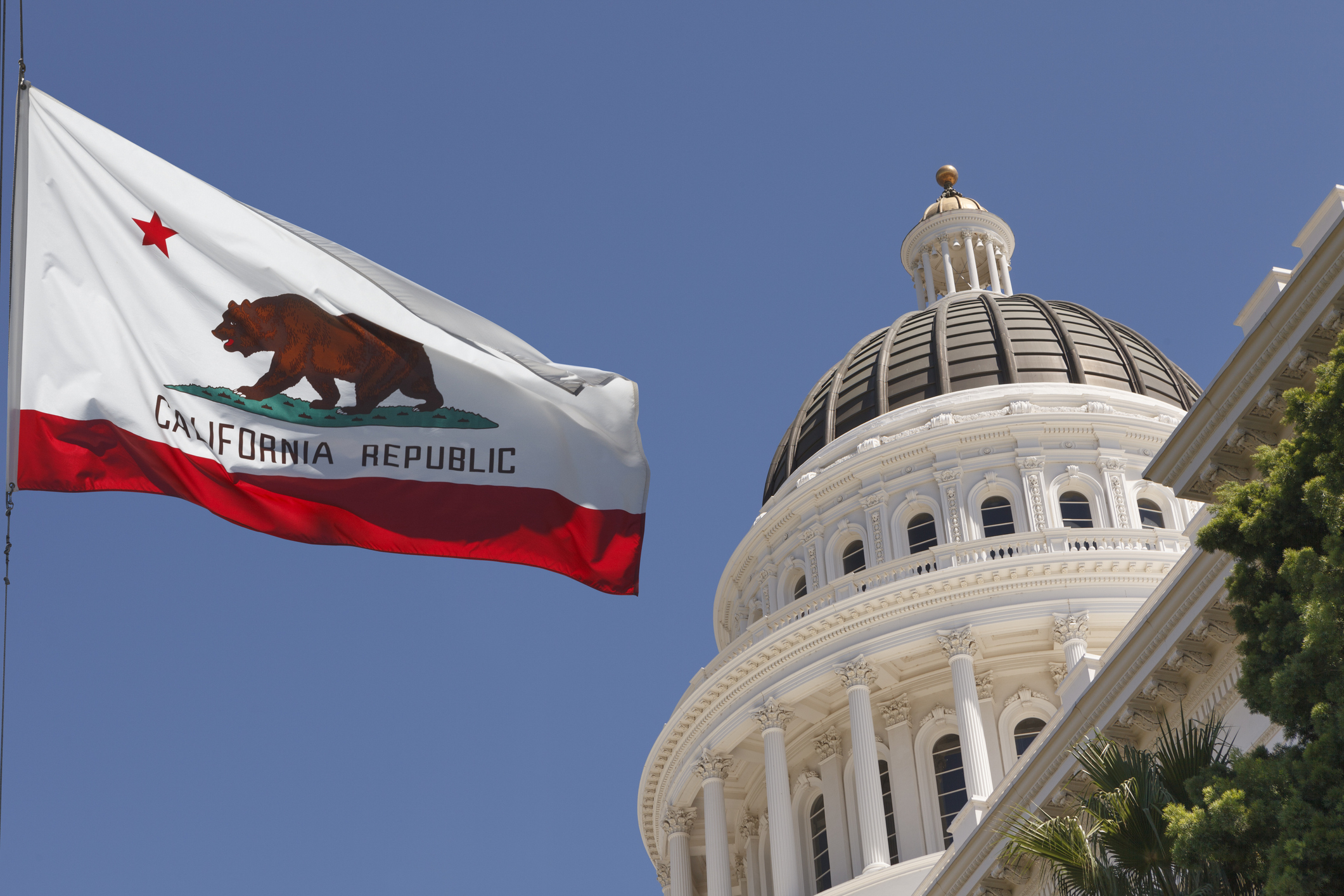 California State Capitol and California flag in Sacramento