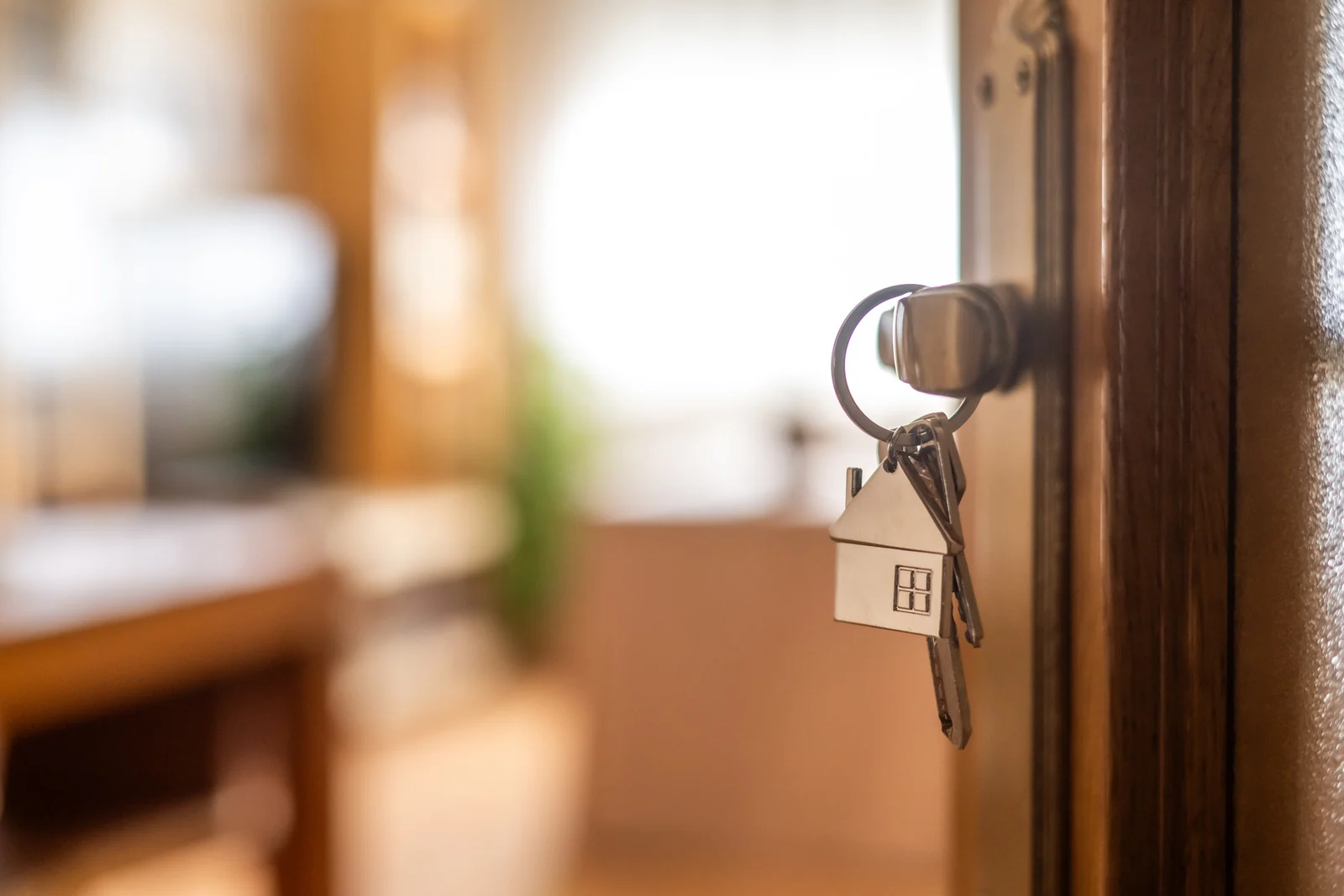 House key in the door of a home already owned